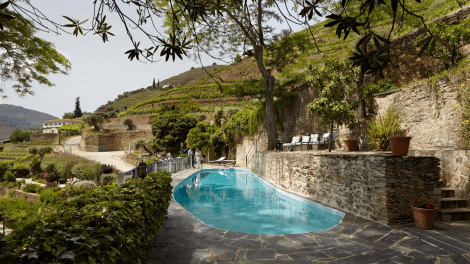  Quinta de la Rosa hotel, pool with stunning view, spa treatment room, gourmet restaurant cuisine, wine tasting experience, Douro Valley landscape.
